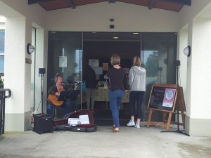 Kerryn playing guitar at entrance to the